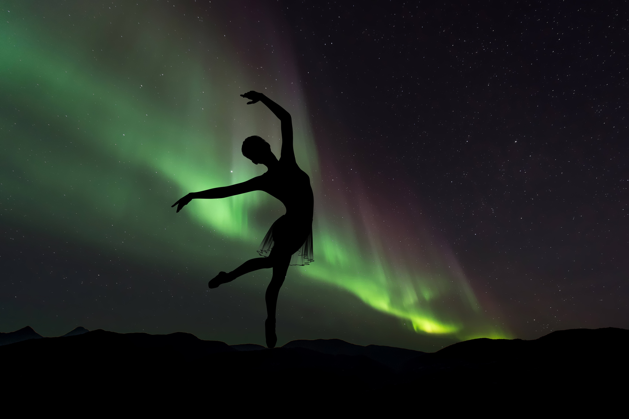 Silhouette Of Ballet Dancer On Northern Lights